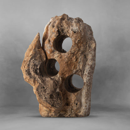 Stalagmite, rough stone in brown and gray, appealing onyx wine rack, 3 bottles